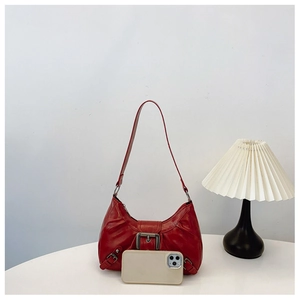 Detail view of red Y2K retro shoulder bag with vintage metal buckle and leather texture