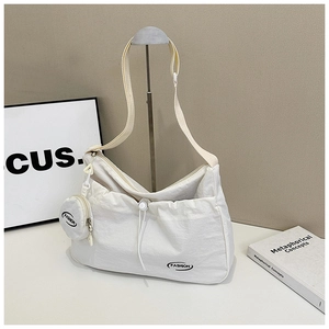 Minimalist beige nylon crossbody bag with adjustable strap and small round coin purse