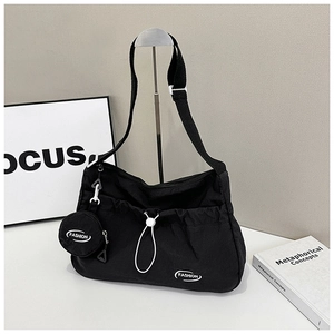 Waterproof black nylon crossbody bag with drawstring pocket and round coin purse charm