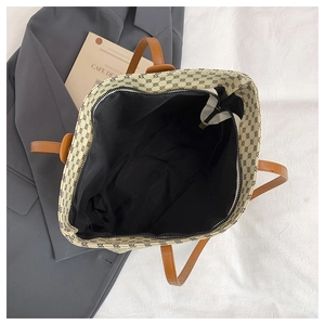 Detailed top view of a large tote bag showing black fabric lining and secure zipper closure