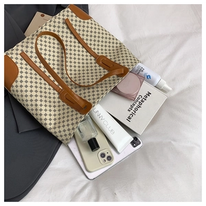 Detailed interior view of a large tote bag showing high capacity for books and phone