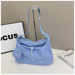 Light blue nylon hobo crossbody bag with a round coin purse and white drawstring detail