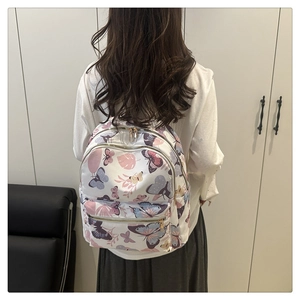 Fashionable floral backpack with purple butterfly prints and gold zipper hardware