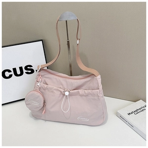 Pink waterproof nylon crossbody bag with drawstring and matching round coin purse