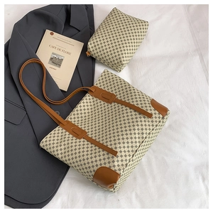 Detail of canvas tote bag and matching pouch with dot print and brown leather handles