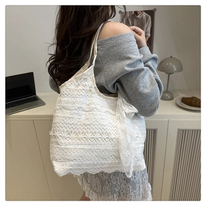 Detailed view of white floral lace tote bag showing intricate mesh texture and large size