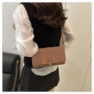 Retro brown canvas crossbody bag with flap closure and textured fabric detail