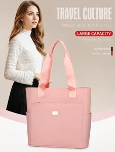 Detail showing the pink Oxford fabric texture and front zipper pocket of the large tote