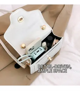 Internal view of the white flap bag showing space for phone, lipstick and perfume