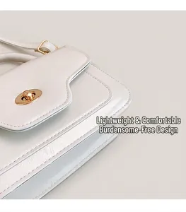 Detail of white leather small square bag with golden twist lock and refined texture