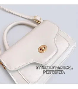 Detail of white wrinkled leather handbag with gold twist-lock and circular top handle