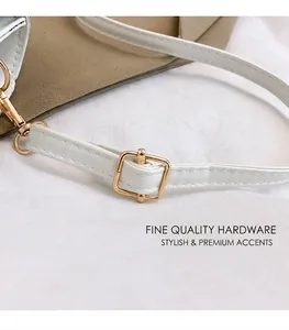 Close-up of white leather shoulder strap with premium gold metal adjustment buckle