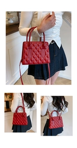 Detail of red quilted faux leather handbag showing stitching and detachable strap