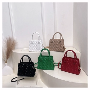 Quilted crossbody tote bags in multiple colors displayed on elegant white steps