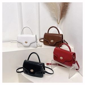 Close-up of four retro square handbags with glossy finish and metal twist locks