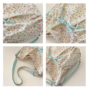 Detail view of floral canvas tote bag featuring button closure and adjustable strap