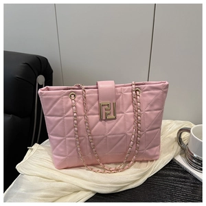 Detail of pink quilted faux leather tote bag with gold logo and metal chain strap