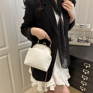 Elegant white vintage evening bag with textured dot fabric and gold chain strap
