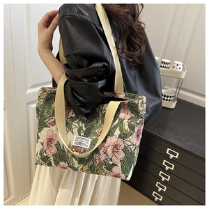 Detail of floral tote bag with woven handles and vintage botanical pattern on canvas