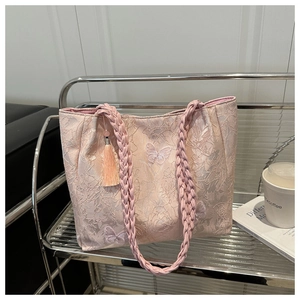 Detailed pink lace tote bag with butterfly embroidery and woven rope handle design