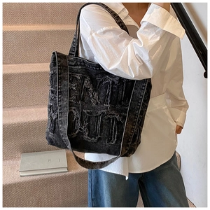 Detail of Feel Out vintage black washed denim tote bag with frayed letter patchwork