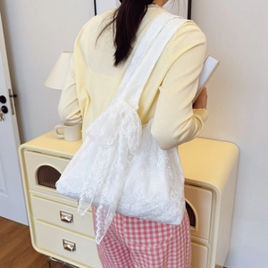 White floral lace tote bag with embroidery and bow straps for summer vacation style