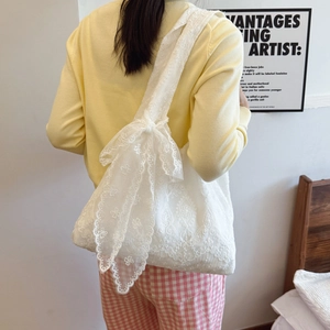 White floral lace tote bag with bow straps and scalloped edges for summer outings