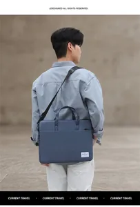 Man carrying a dark blue slim laptop bag with handle and adjustable shoulder strap outdoors