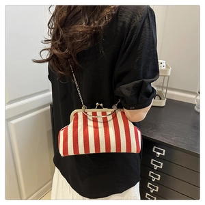 Detail of vintage red and white striped shell bag with gold chain and metal handle