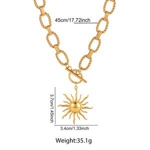 Detail view of gold sun pendant necklace with OT toggle clasp and size dimensions