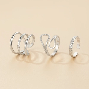 Three-piece silver stainless steel open ring set with irregular and twisted textures