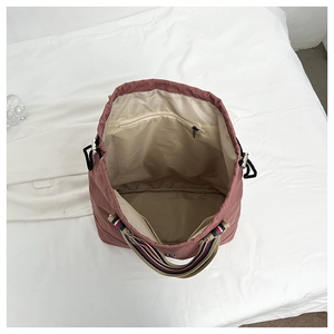 Top view of pink tote bag interior showing spacious compartments and striped handles