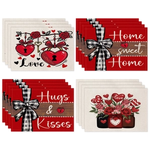 Détail de quatre sets de table en lin pour la Saint-Valentin avec roses et cœurs