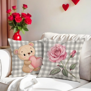 Pink Valentine cushion covers with cartoon bear and rose patterns on a white sofa