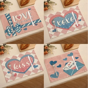 Détail de quatre sets de table en lin pour la Saint-Valentin avec motifs de cœurs