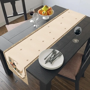 Detail of moon print table runner with hanging lanterns on dark wooden dining table