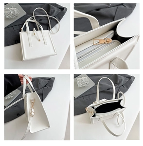 Macro view of white square crossbody bag showing gold zipper and leather texture