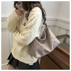 Detail of grey marble silk shoulder bag with ruffled strap and stylish pleats design