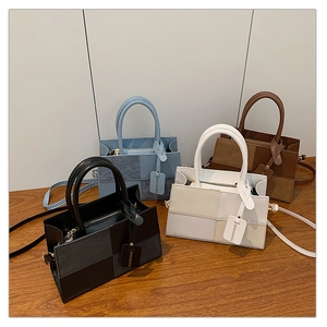 Collection of color-block tote bags in black, blue, beige, and brown with top handles