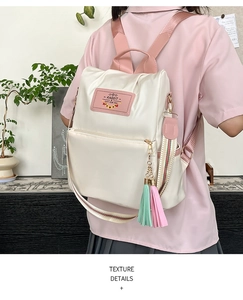 Detail of retro white backpack with pink straps and a Rabbit Gift for You leather patch