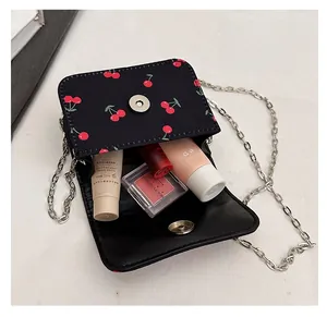 Interior view of black cherry print bag showing storage space for lipsticks and makeup
