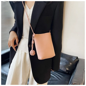 Pink lychee texture leather mini crossbody bag with unique braided knot shoulder strap detail