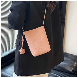 Pink pebbled leather phone bag with shoulder strap and knot tassel detail