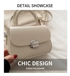 Detailed side view of beige PU leather handbag with silver rectangular metal clasp and handle