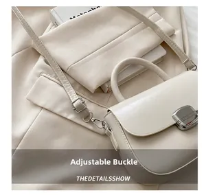 Close-up of beige handbag featuring a silver rectangular buckle and adjustable strap detail