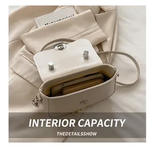 Detail view of the beige leather bag interior showing space for phone and wallet