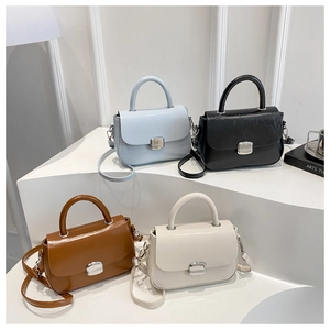 Group shot of minimalist square handbags in blue, black, brown and beige colors
