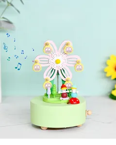 Macro detail of wooden ferris wheel music box with flower petals and wind-up knob