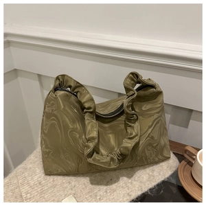 Detail of green marble pattern fabric and pleated handle on cloud style handbag