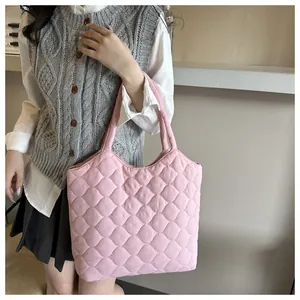Detail of pink quilted tote bag showing high-capacity design and puffer material texture